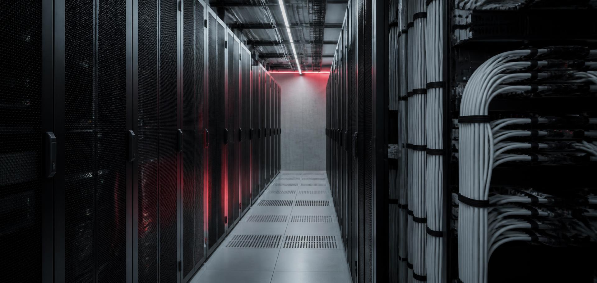 Colocation server aisle with neatly routed fibre optic cabling and a red accent light
