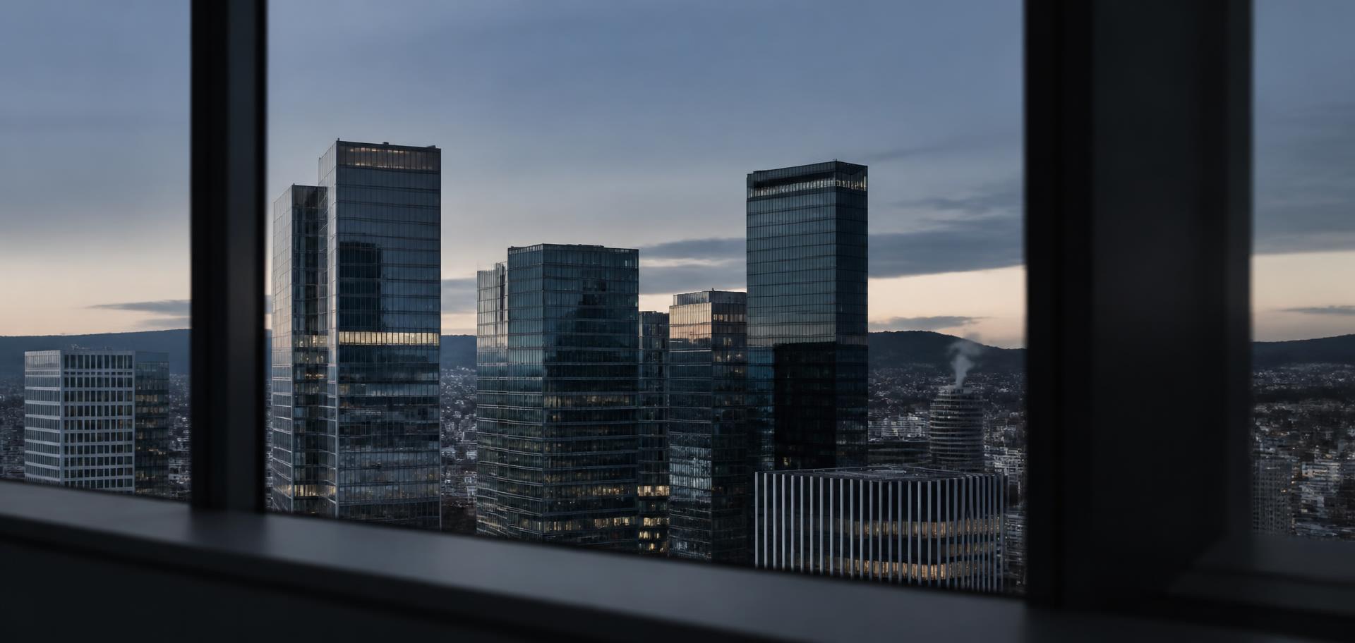 Financial district towers at blue hour seen through an office window frame