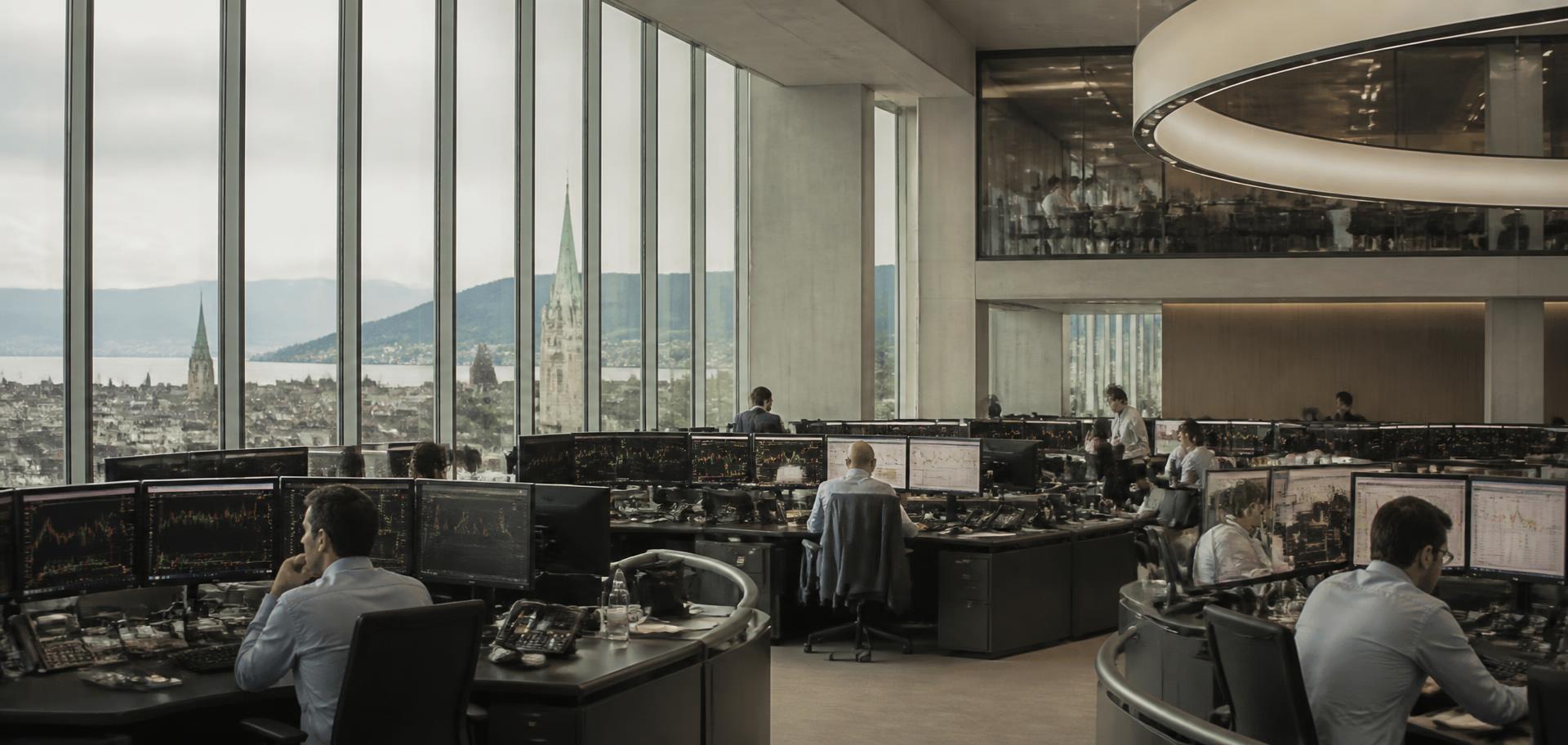 Equity trading floor in Zurich with analysts at multi-screen desks and the city skyline behind